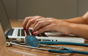 medical professional working on a macbook