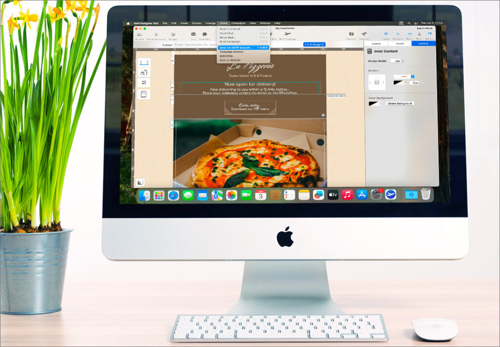 An iMac displaying the Mail Designer 365 application. The main window displays an email template for "La Pizzeria" with a pizza image, and a dropdown menu from the "Campaigns" tab is open, showing options like "Send via SMTP account..." This demonstrates the software's email design and sending capabilities. A white keyboard and mouse are on the desk in front of the iMac, and a potted plant is on the left. 